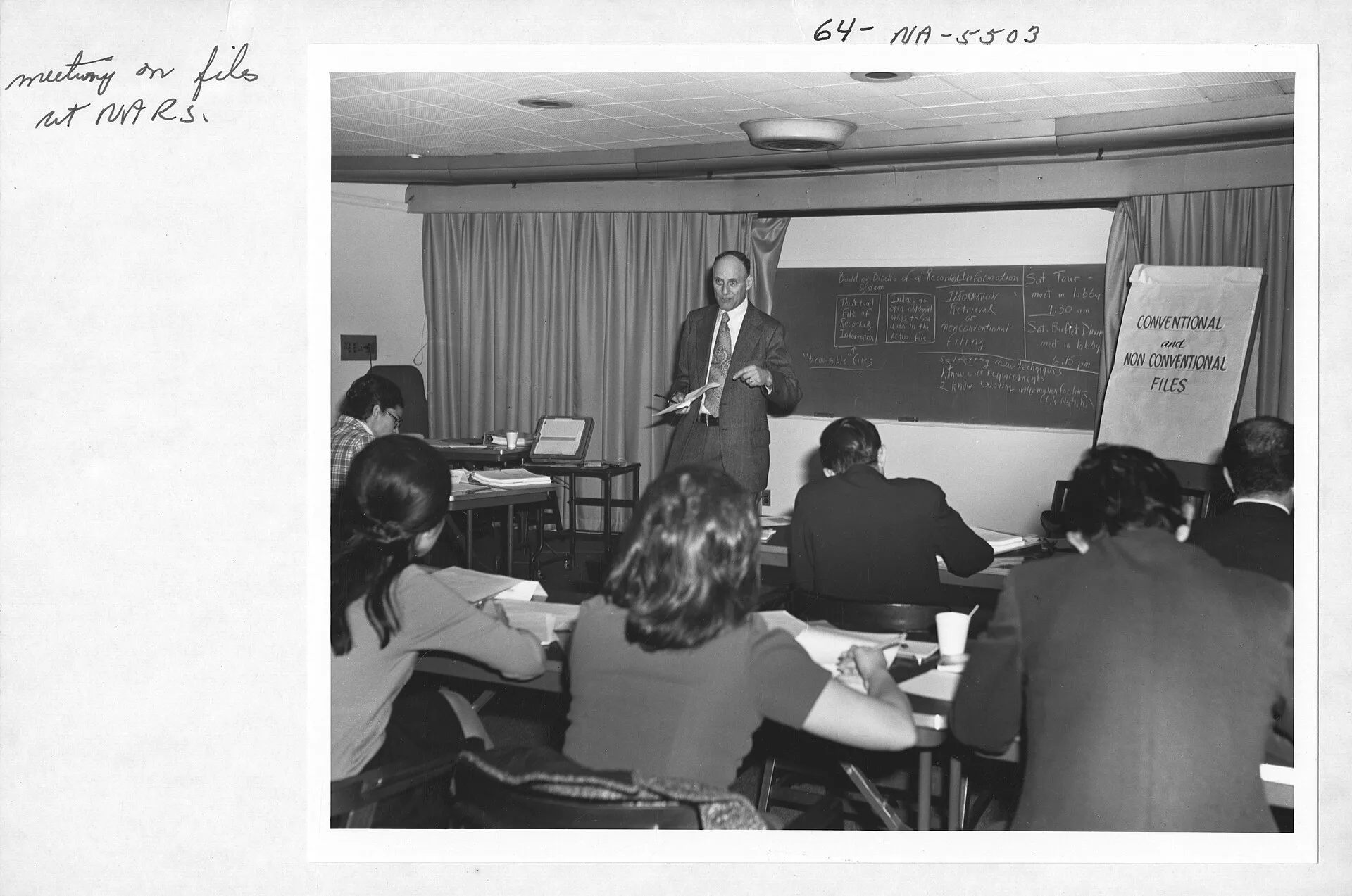 This is a photograph of a workshop on files management for attendees of the International Seminar on Public Records Management, held at the National Archives Building. Filing history list: what the register does not hold and where each item lives